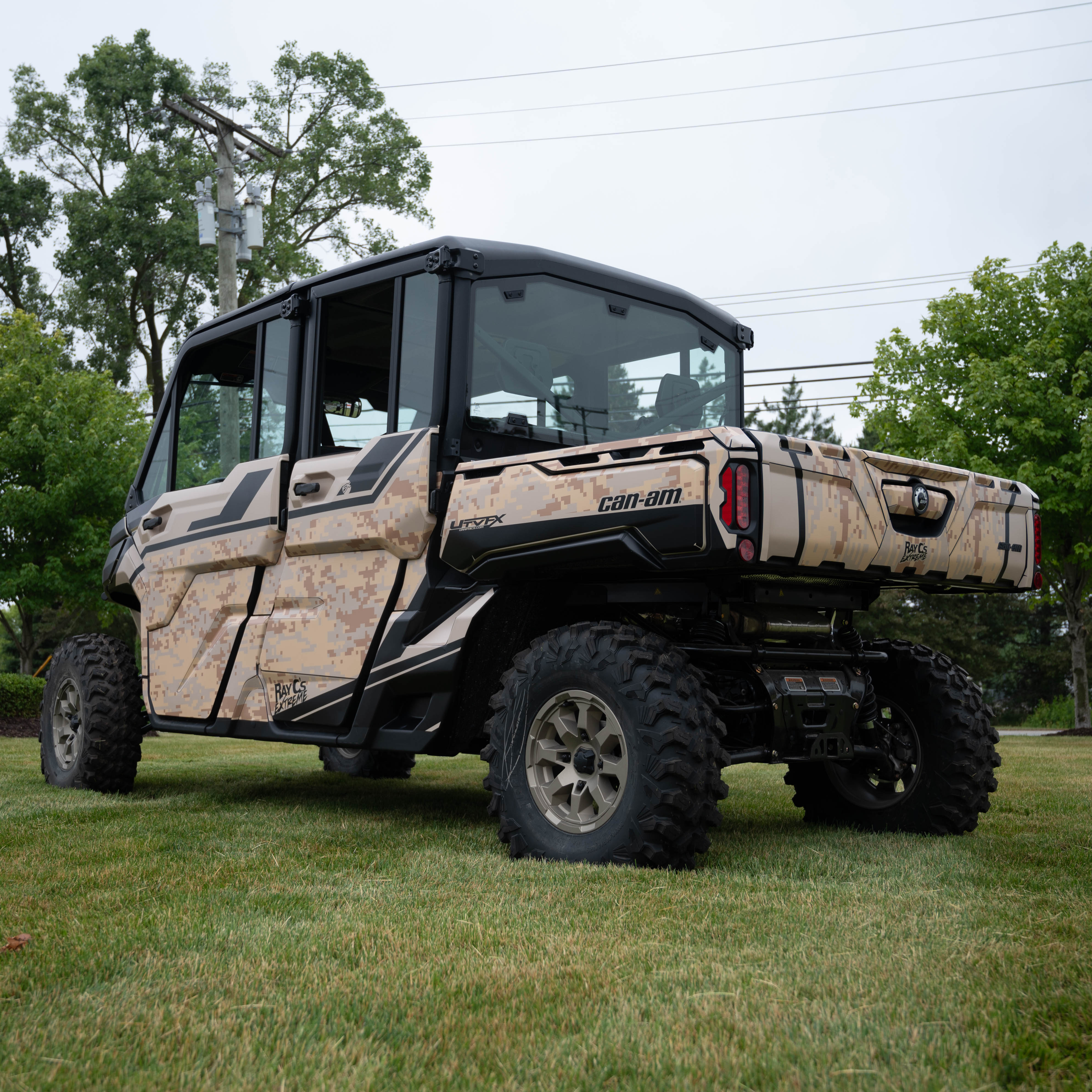A Can-am Defender Max with a tan and black digital camo custom wrap