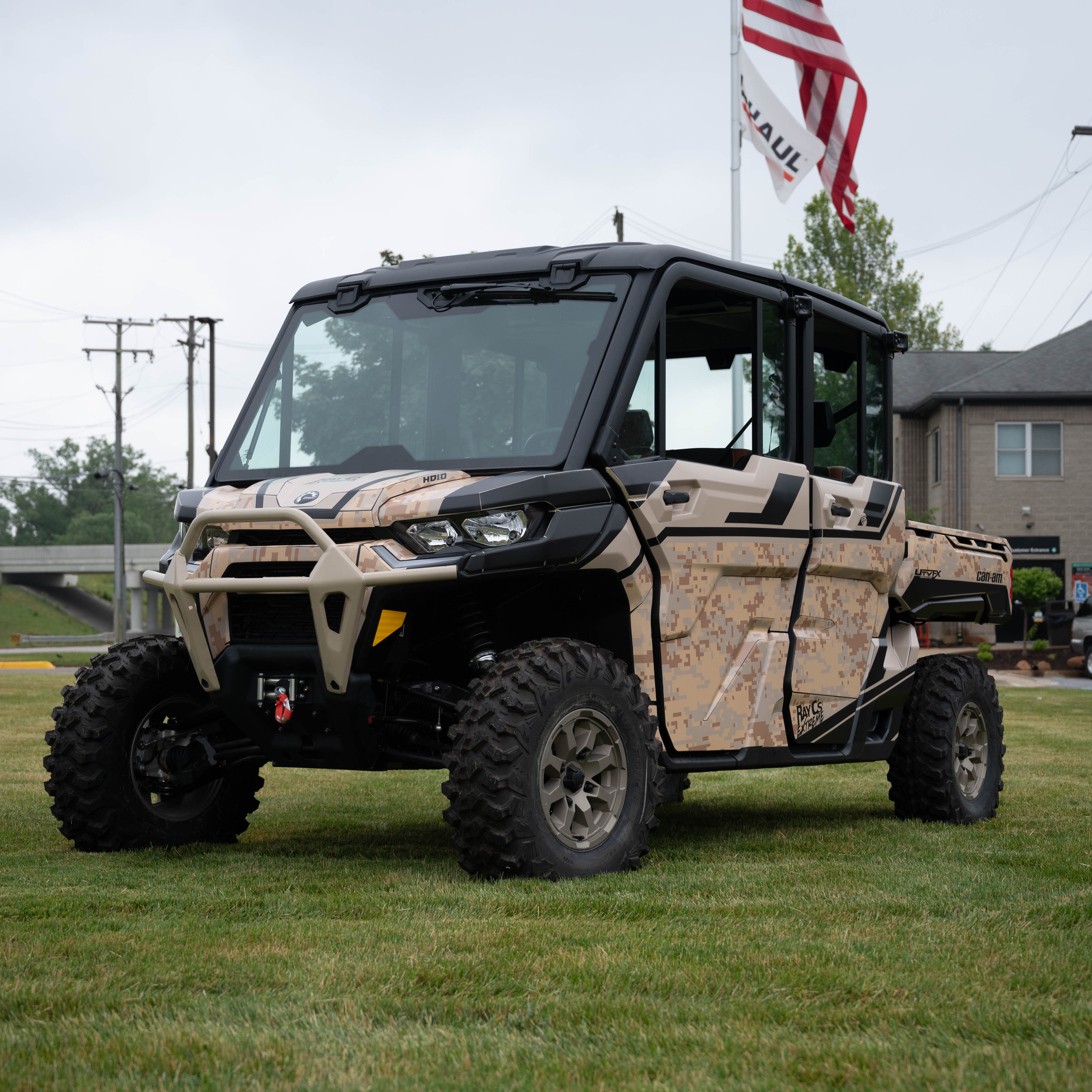 A Can-am Defender Max with a tan and black digital camo custom wrap
