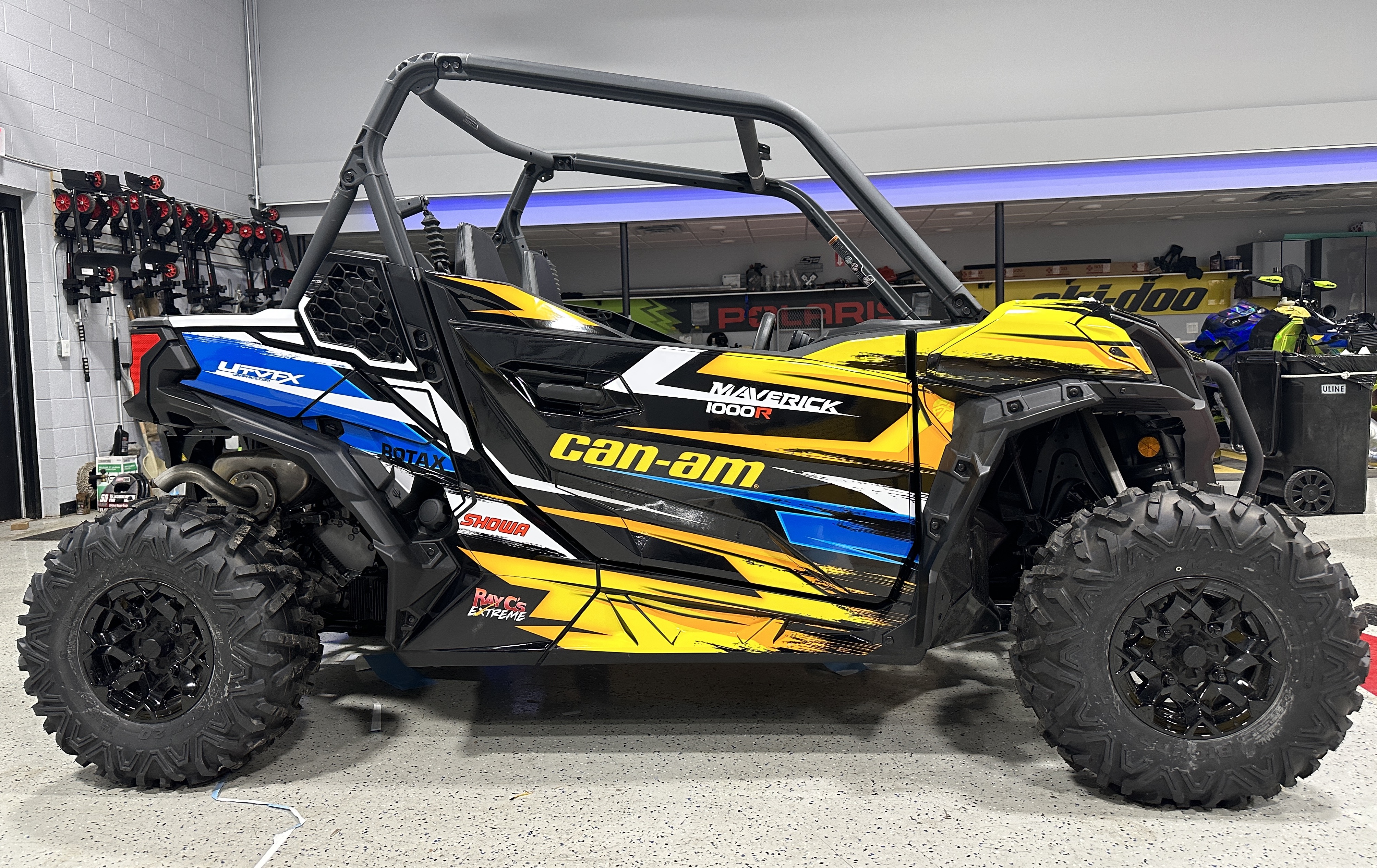 A Can-Am Maverick Sport side-by-side with a Ray C's custom Stripes and Grunge vinyl wrap