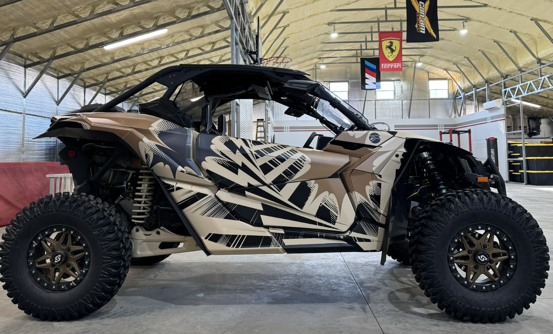 A Can-Am Maverick X3 side-by-side with a Delirious custom vinyl wrap