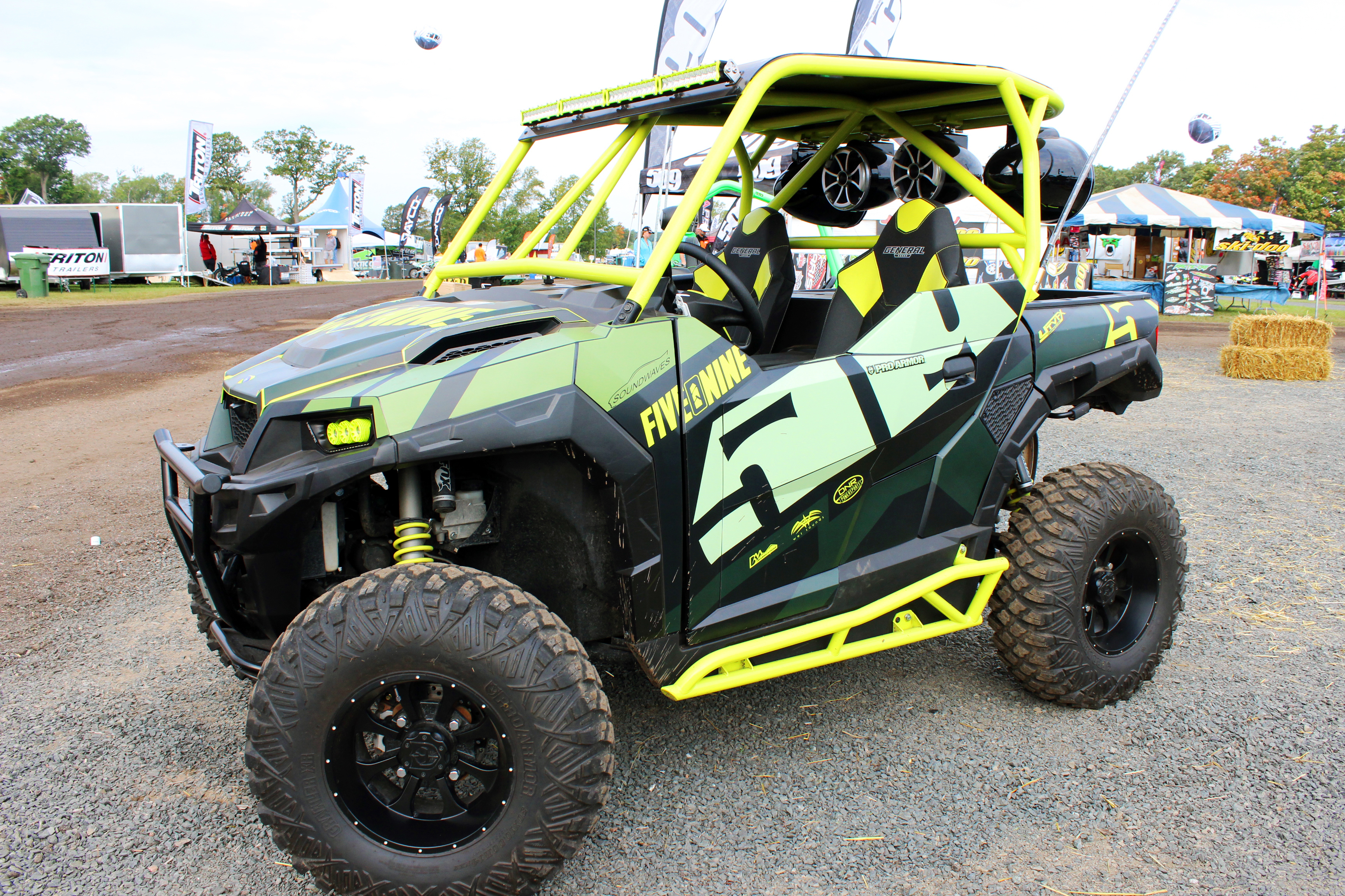 A Polaris General 2 Door side-by-side with a green, black, and gray 509 custom vinyl wrap.