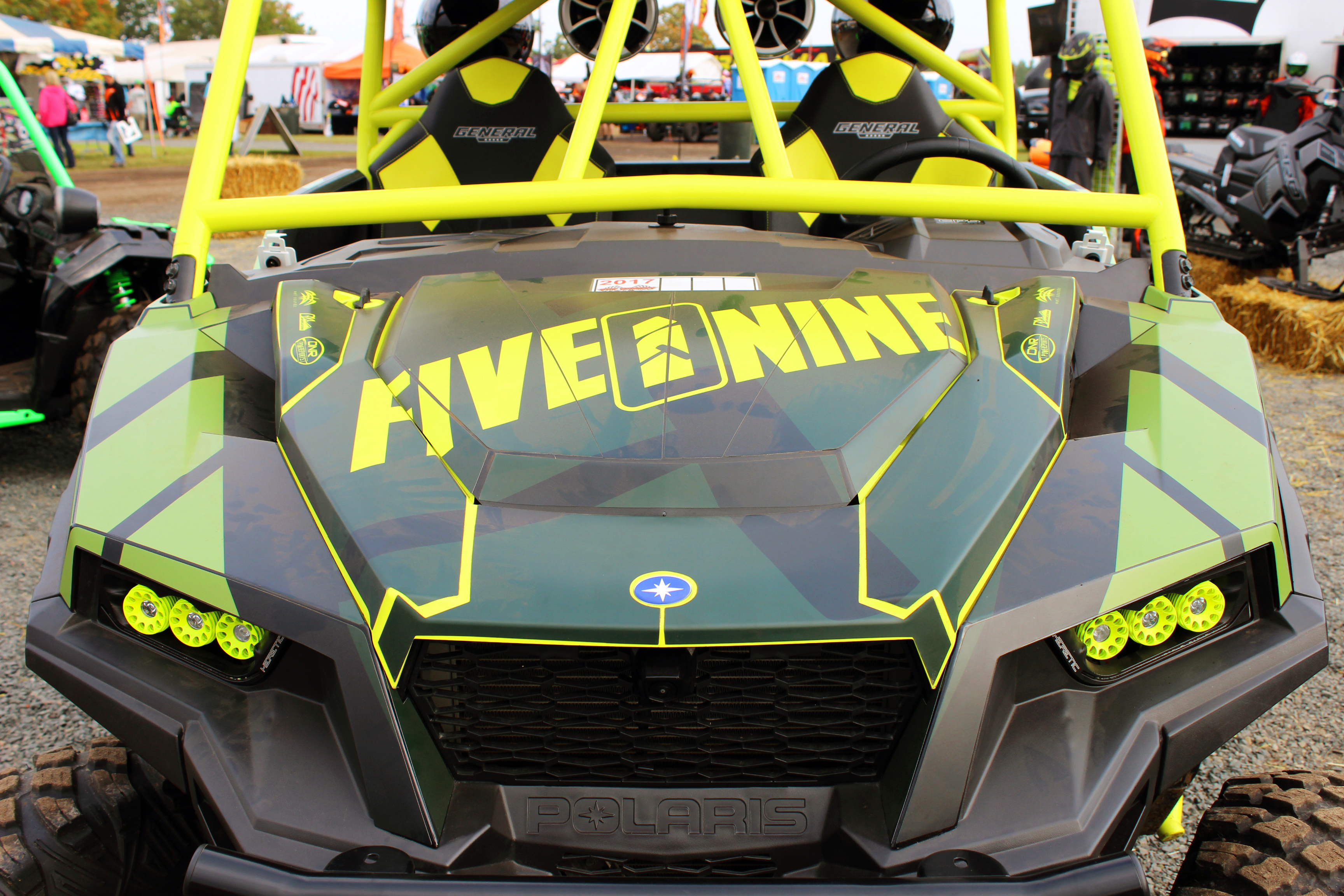 A Polaris General 2 Door side-by-side with a green, black, and gray 509 custom vinyl wrap.