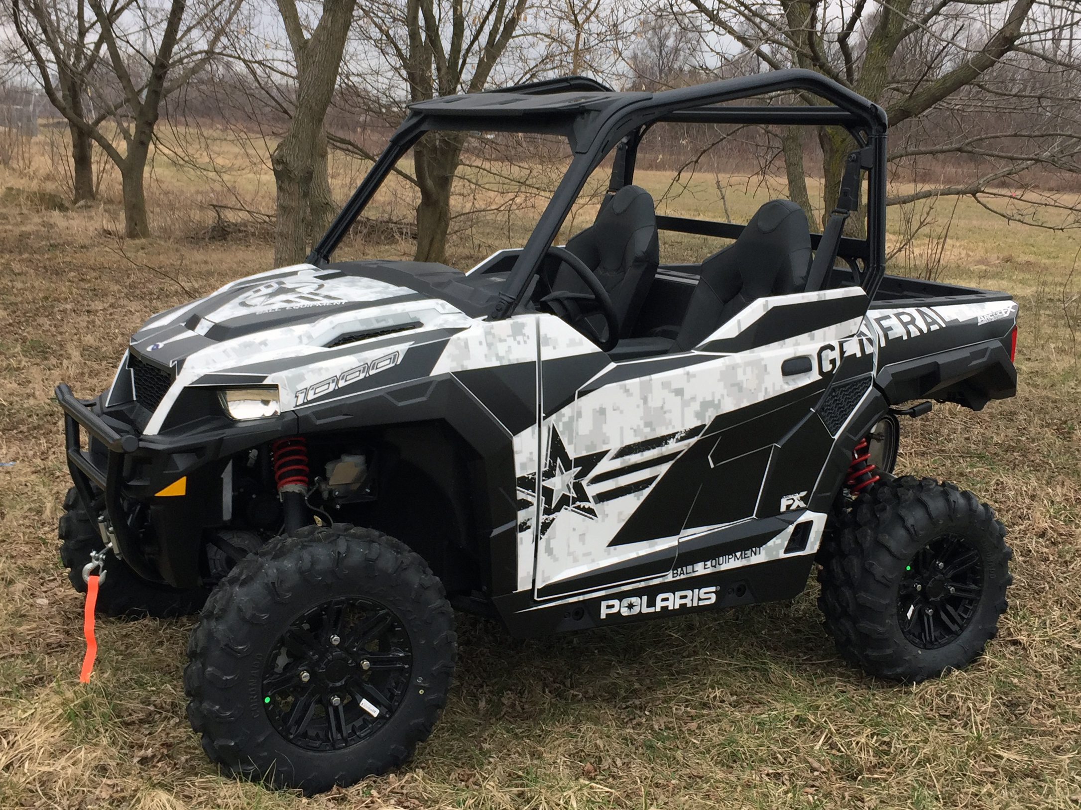 A Polaris General 2 Door side-by-side with a  gray and black digital camo star custom vinyl wrap.