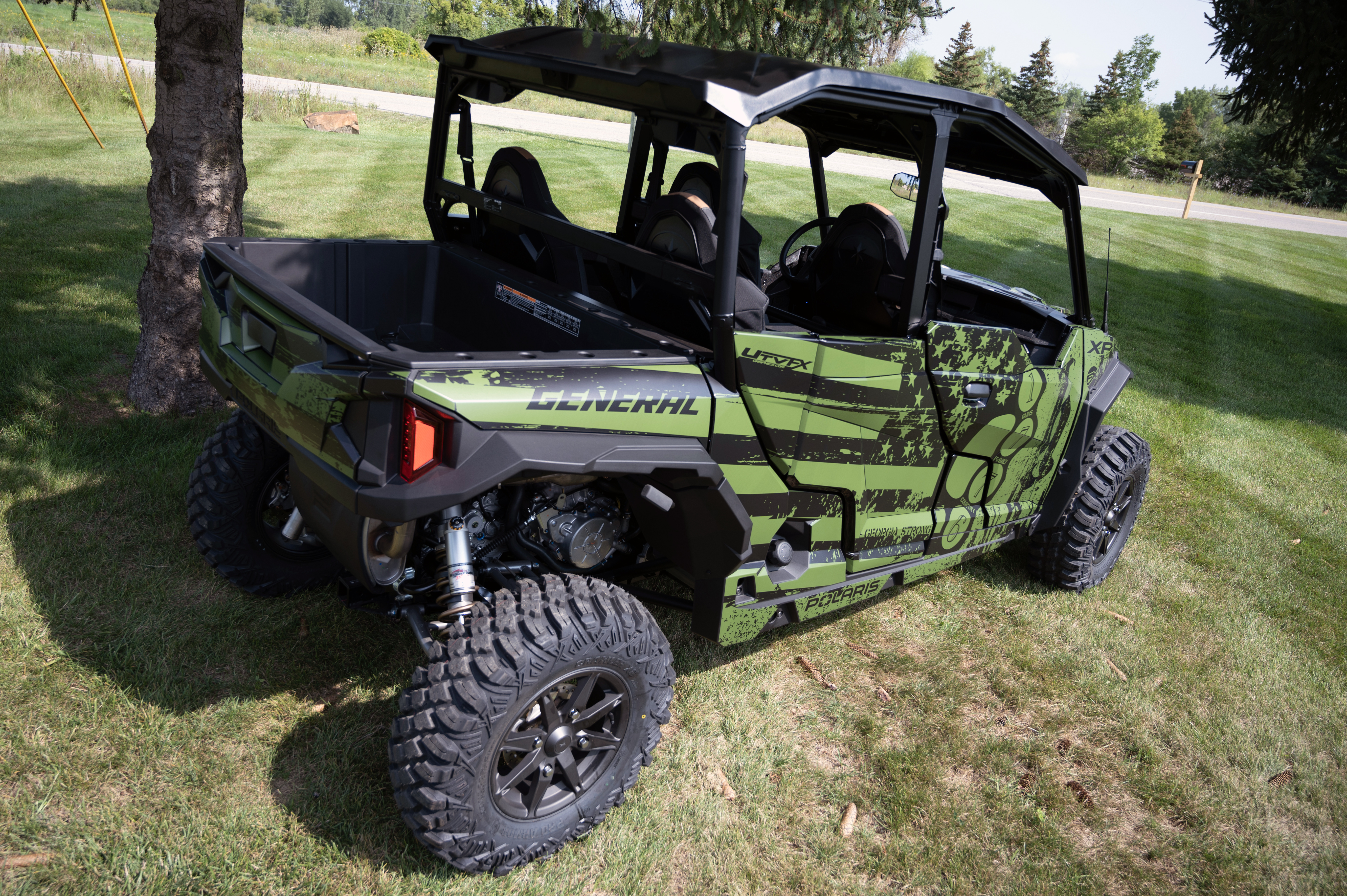 A Polaris General 4 Door side-by-side with a green, black, American Flag custom vinyl wrap.