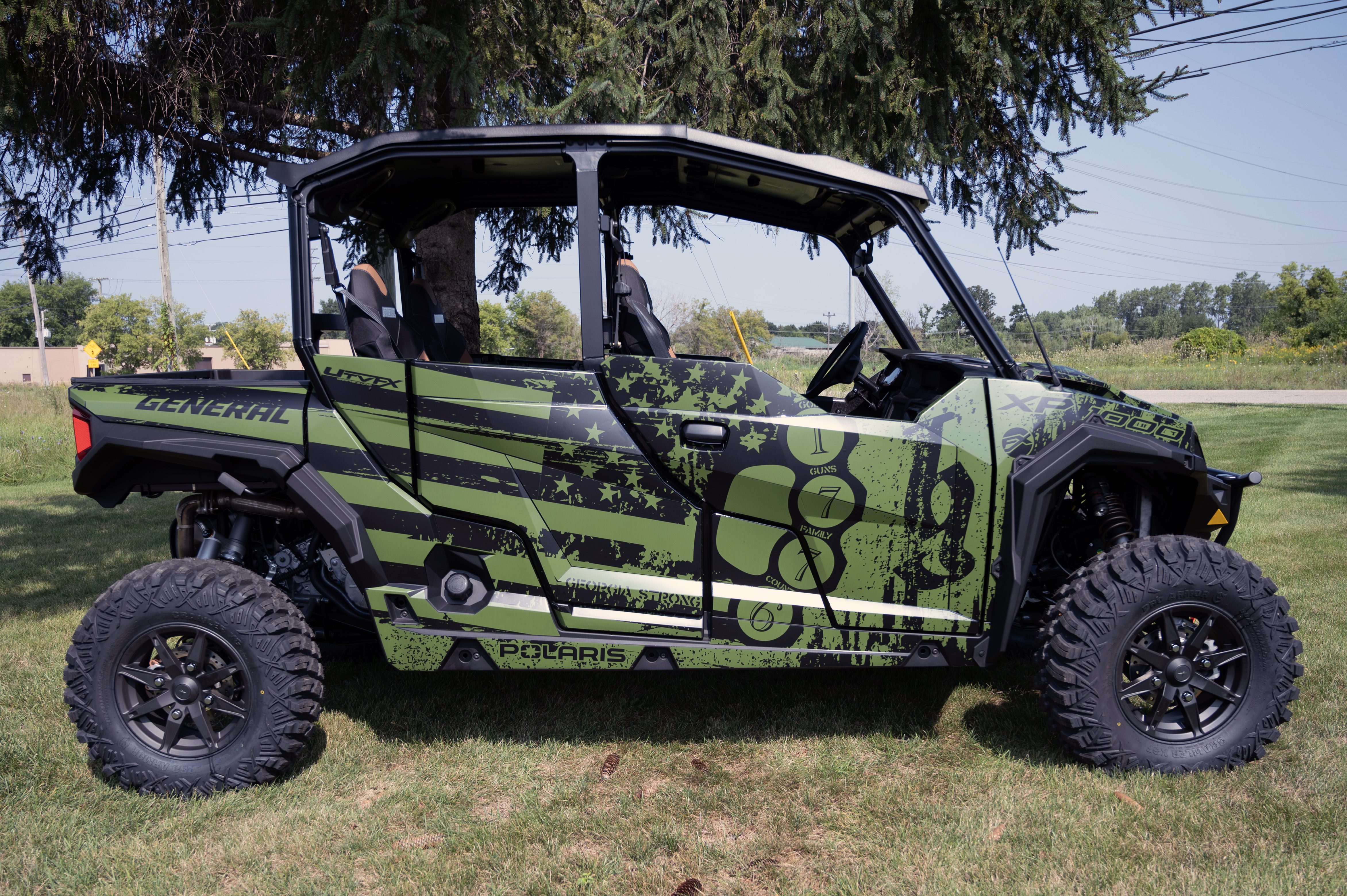 A Polaris General 4 Door side-by-side with a green, black, American Flag custom vinyl wrap.
