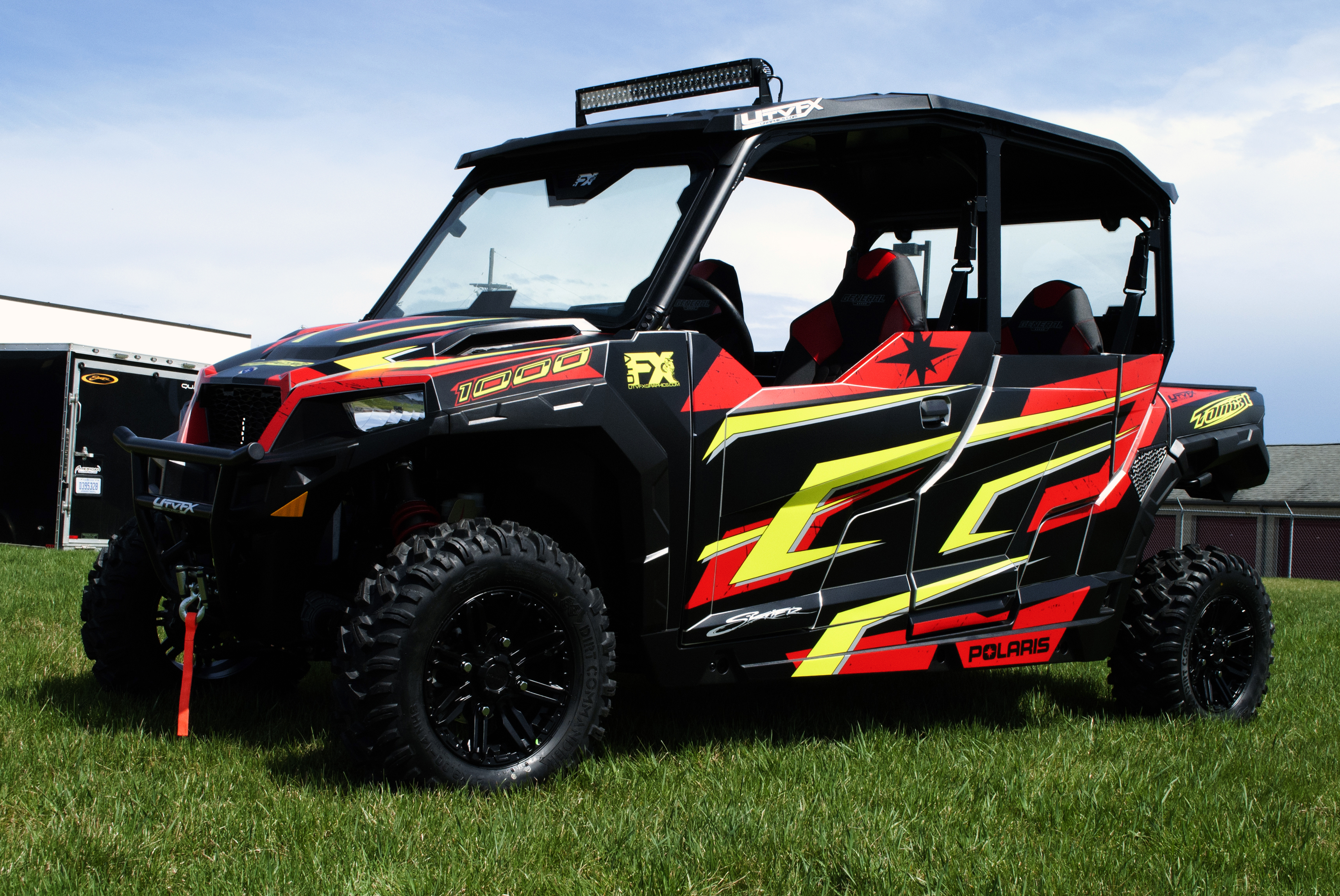 A Polaris General 4 Door side-by-side with a black, red and lime Rogue custom vinyl wrap.
