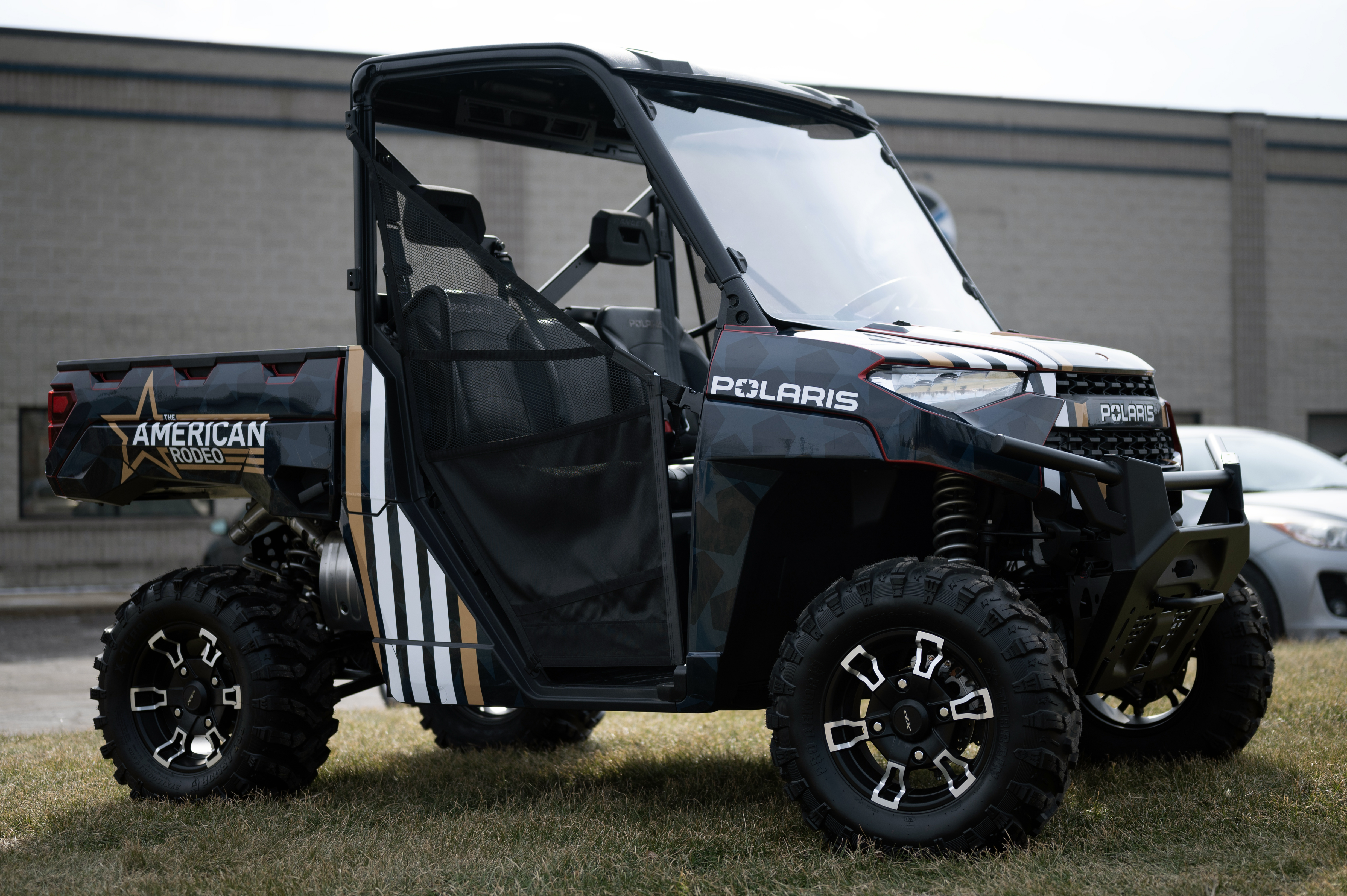 A Polaris Ranger 2 Door side-by-side with an American Rodeo custom vinyl wrap.