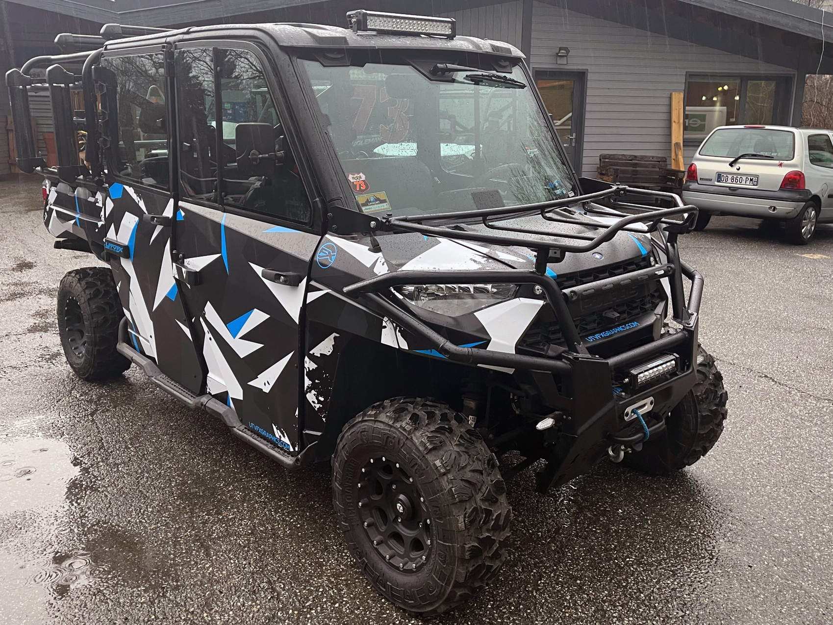 A Polaris Ranger 4 Door side-by-side with a blue, black and white Klim Camo custom vinyl wrap.