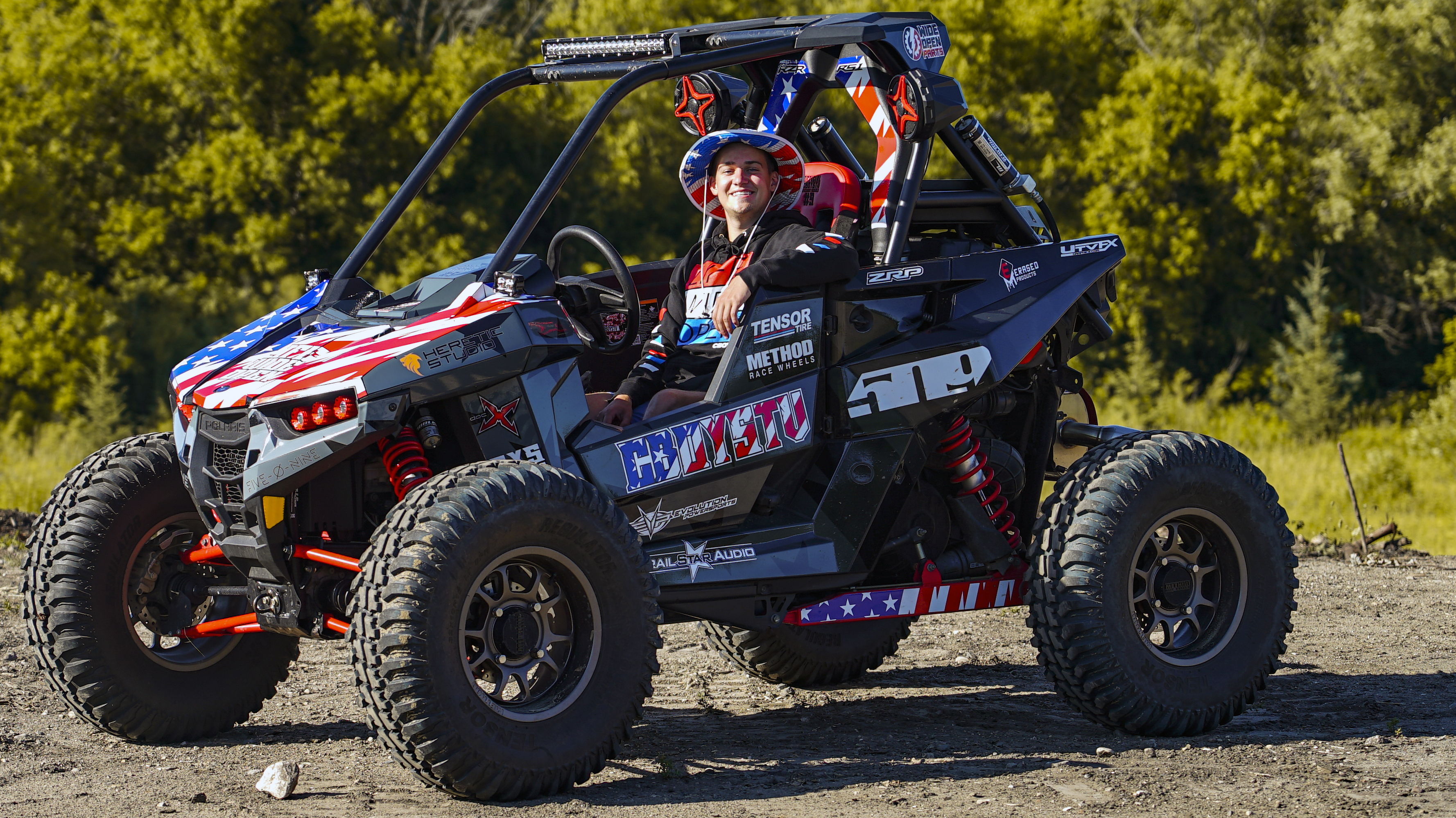 A Polaris RS1 side-by-side with a black and red CboysTV American Flag custom vinyl wrap.