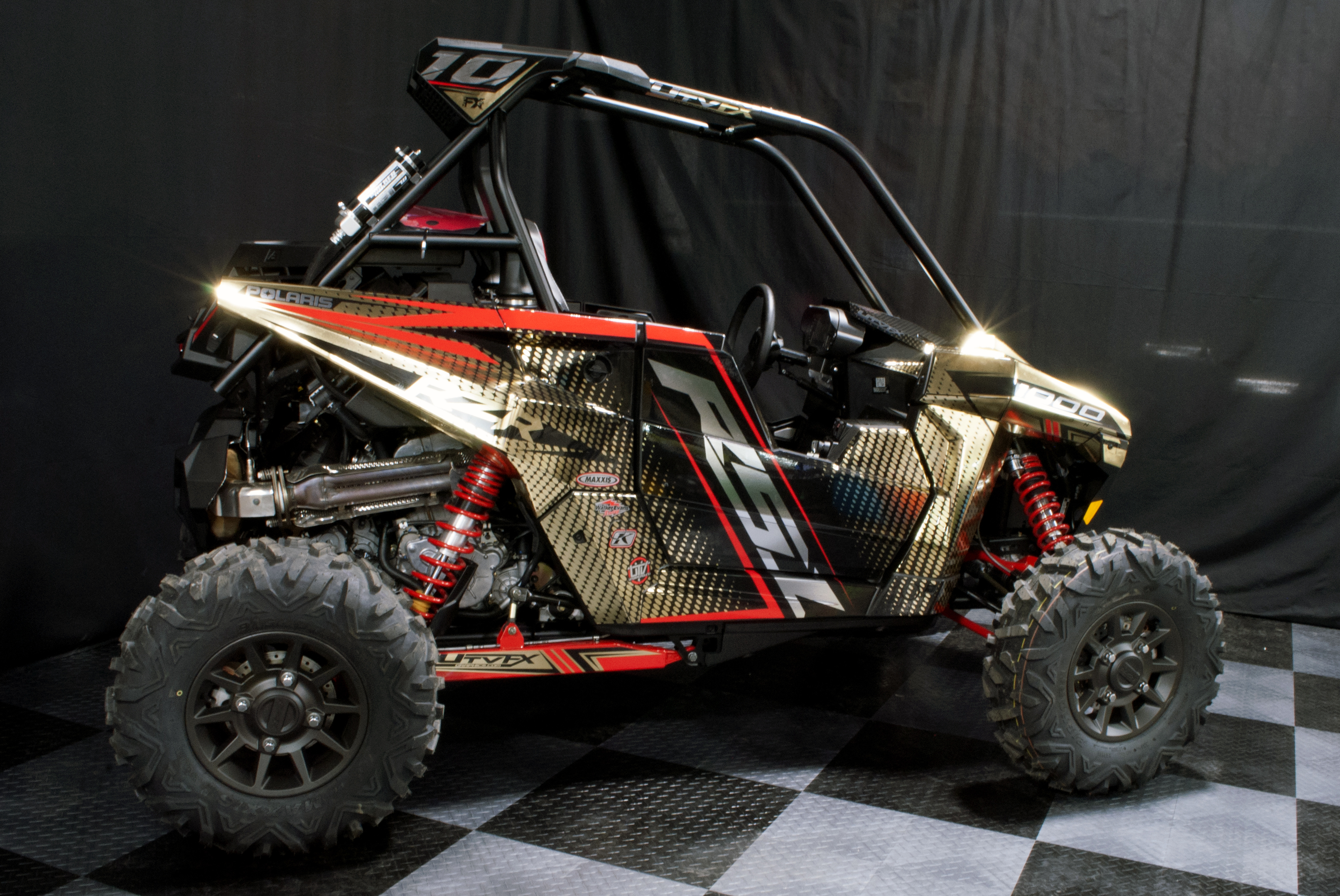 A Polaris RS1 side-by-side with a black, red and gold chrome custom vinyl wrap.