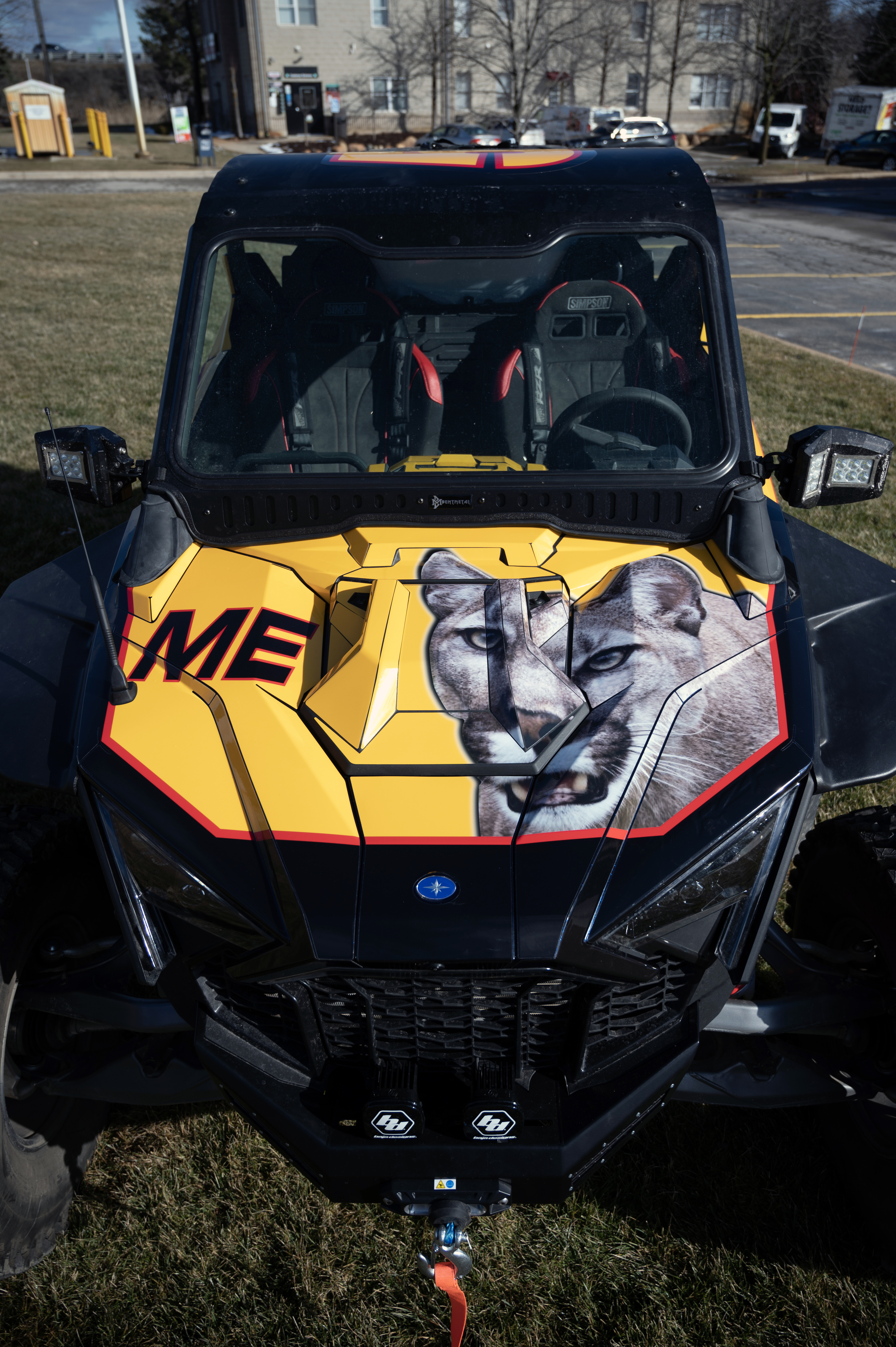 A Polaris RZR PRO XP 2 Door side-by-side with a red, black, and yellow movie replica Ricky Bobby custom vinyl wrap.