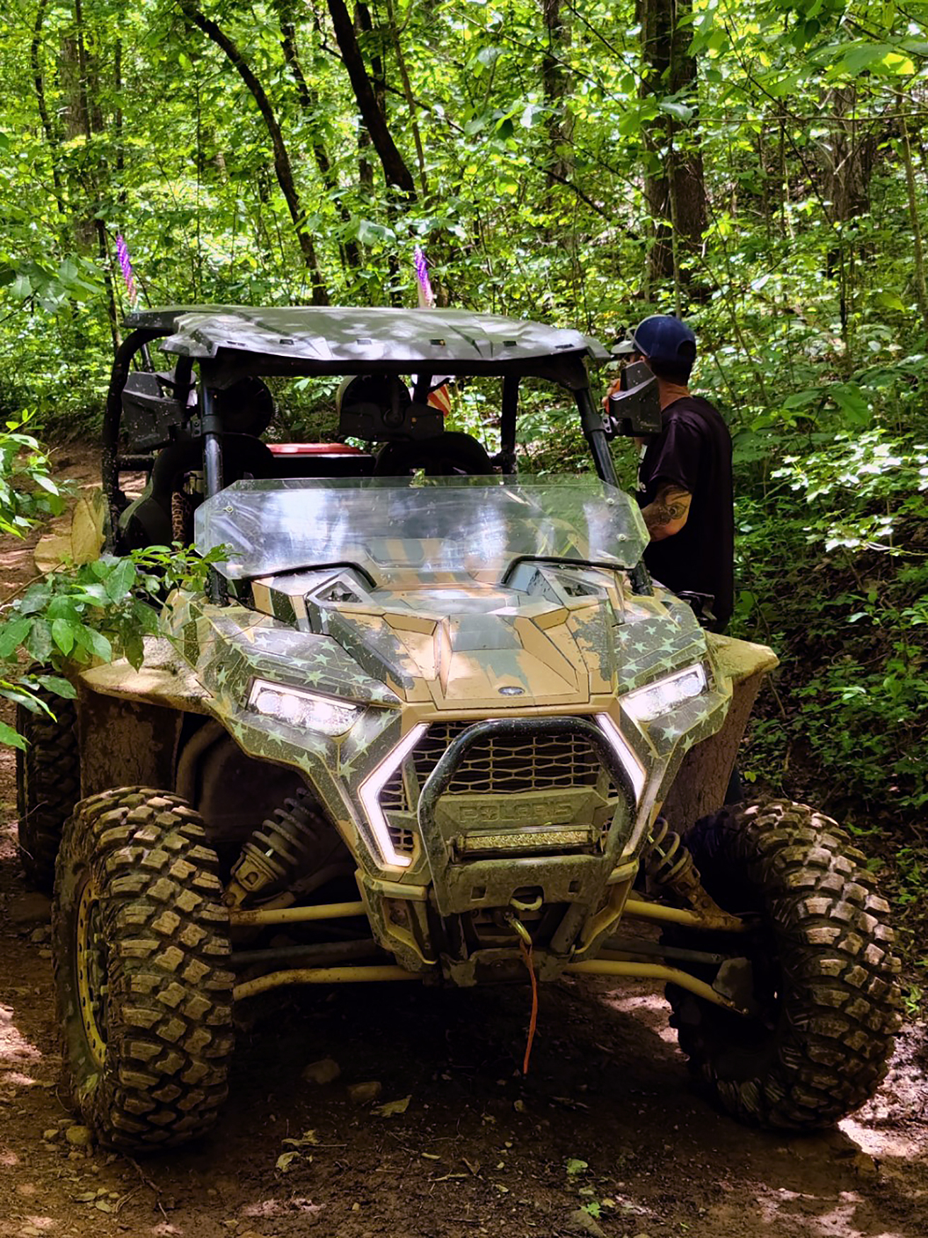 A Polaris RZR XP 2 Door 2018+ side-by-side with a gray, tan, and black grunge American Flag custom vinyl wrap.