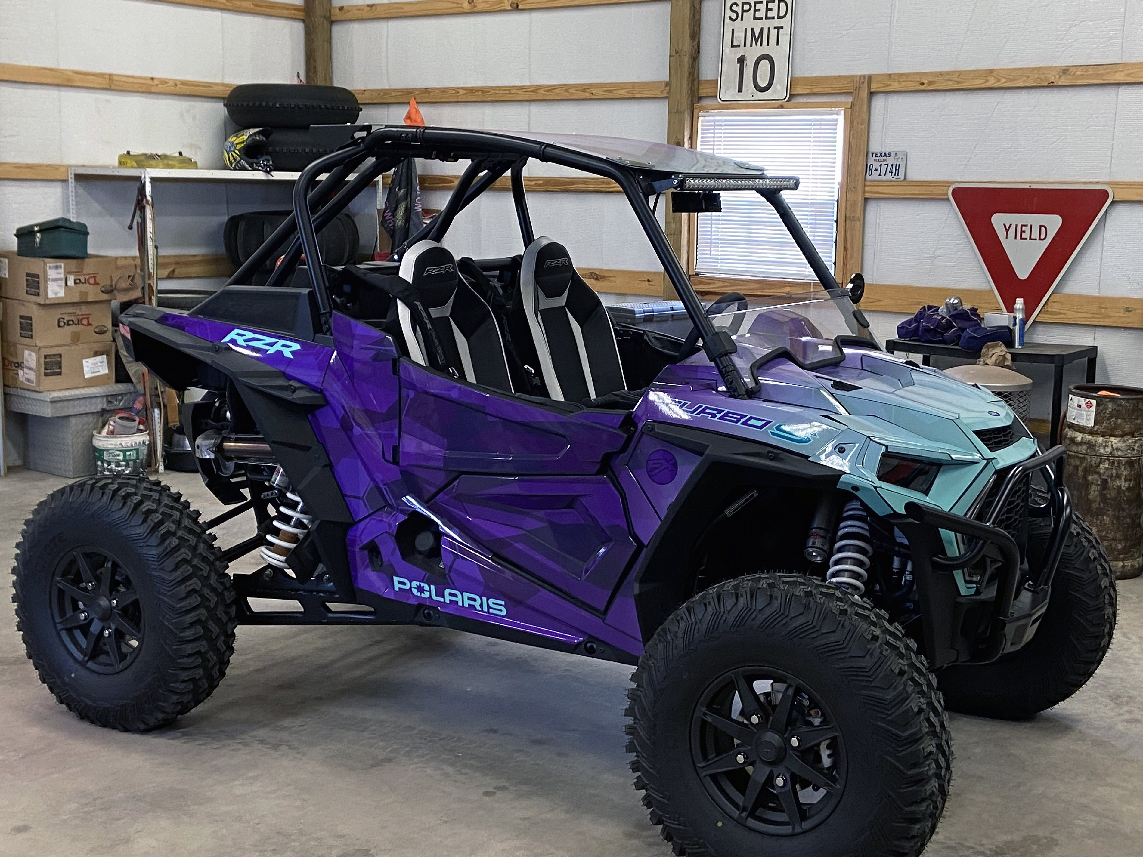 A Polaris RZR XP 2 Door 2018+ side-by-side with a purple, aqua, and blue abstract geometric gradient  custom vinyl wrap.