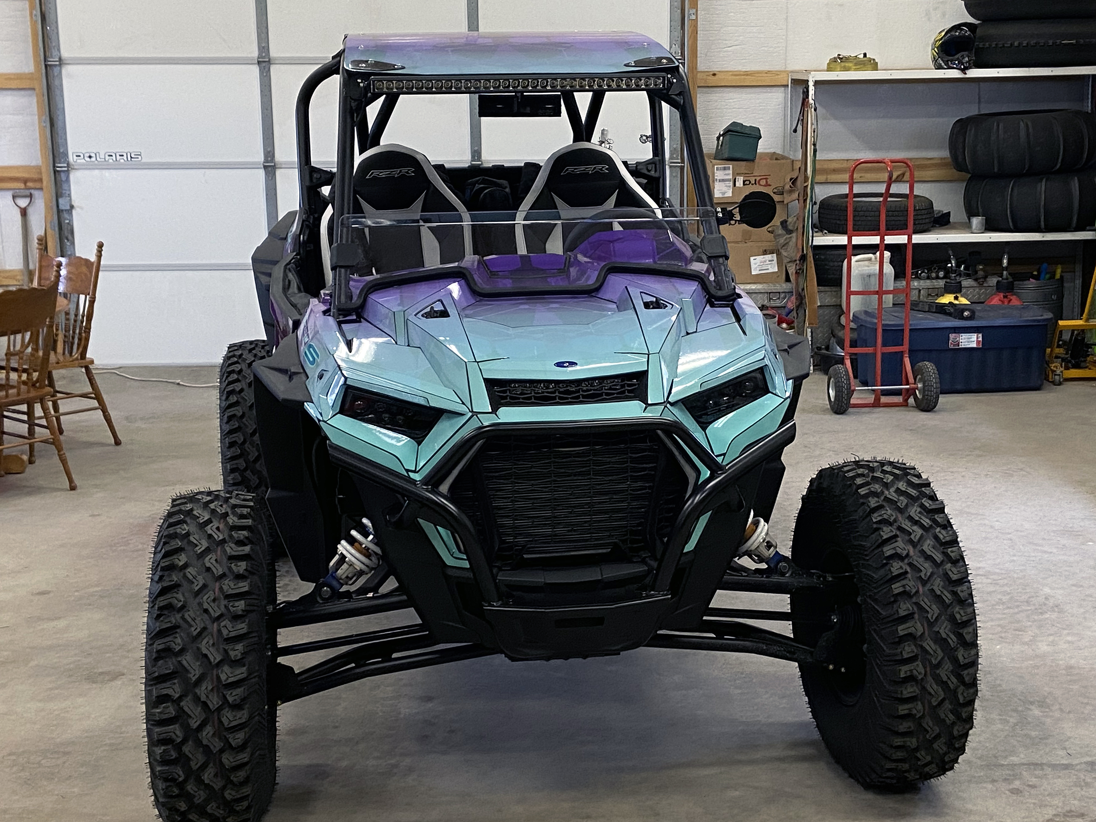 A Polaris RZR XP 2 Door 2018+ side-by-side with a purple, aqua, and blue abstract geometric gradient  custom vinyl wrap.