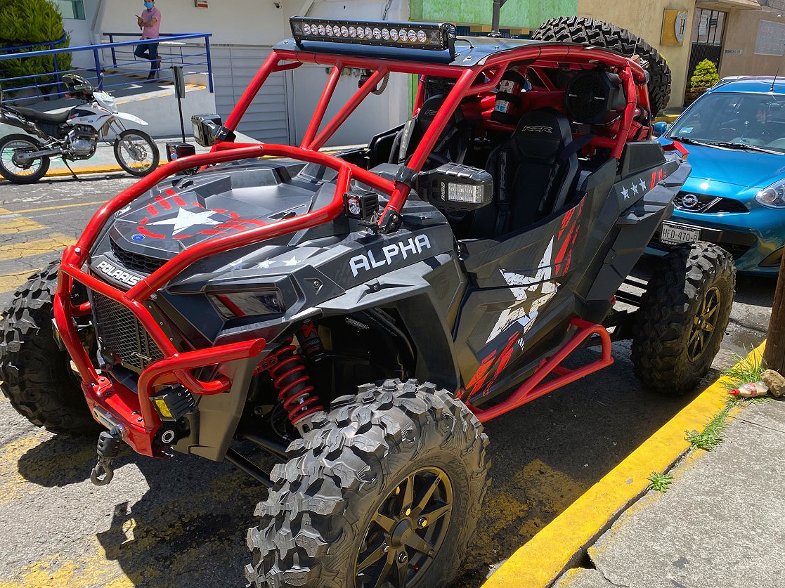A Polaris RZR XP 2 Door 2018+ side-by-side with a red, black, and gray grunge Wartorn custom vinyl wrap.