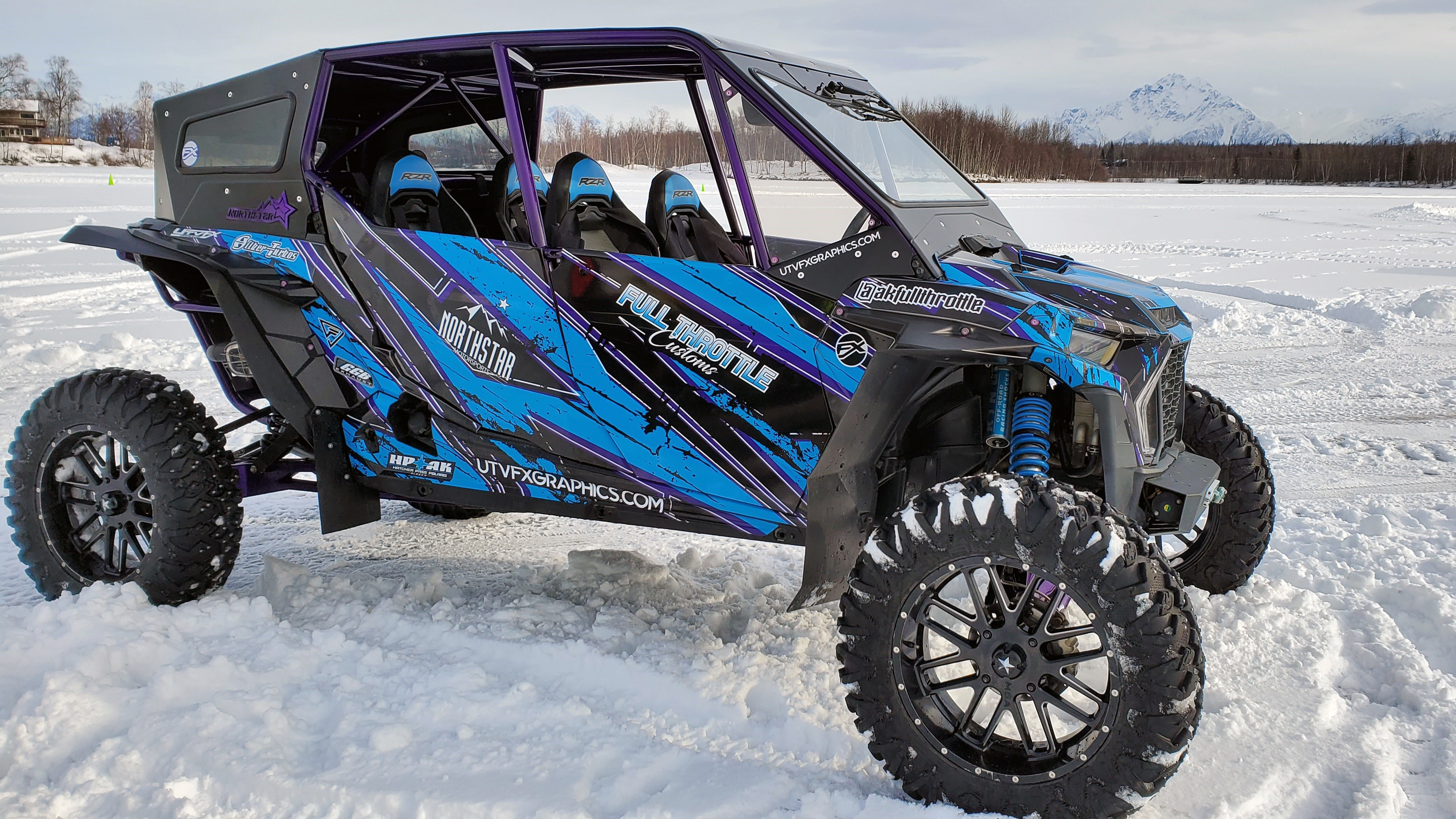 A Polaris RZR XP 4 Door 2018+ side-by-side with a blue, purple, and black grunge Blackout custom vinyl wrap.