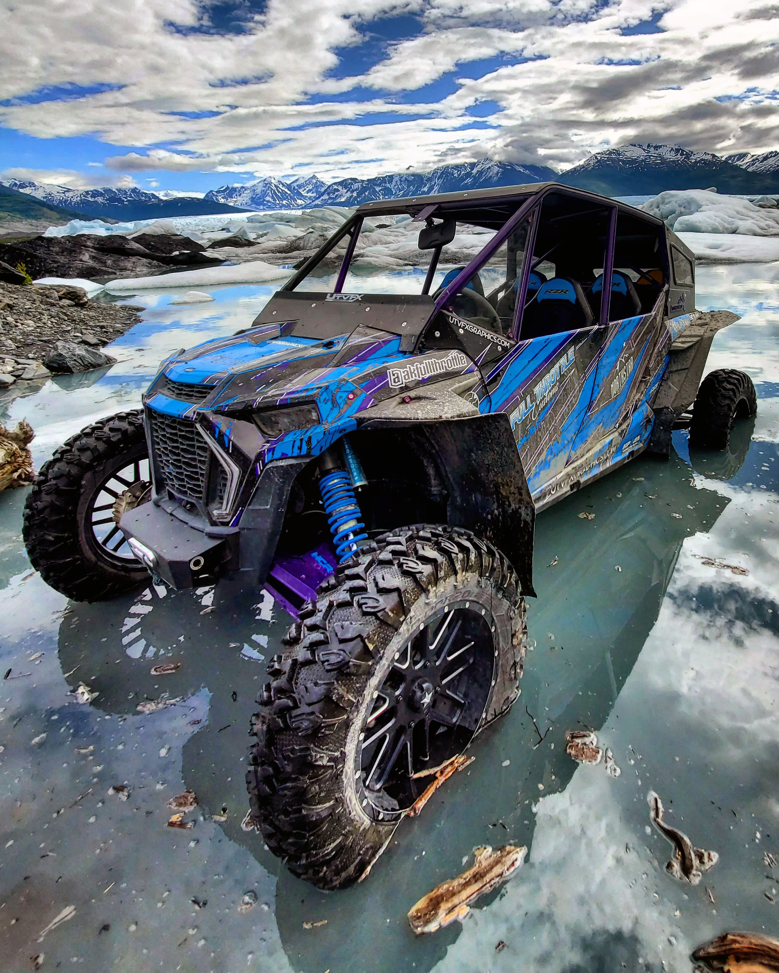 A Polaris RZR XP 4 Door 2018+ side-by-side with a blue, purple, and black grunge Blackout custom vinyl wrap.