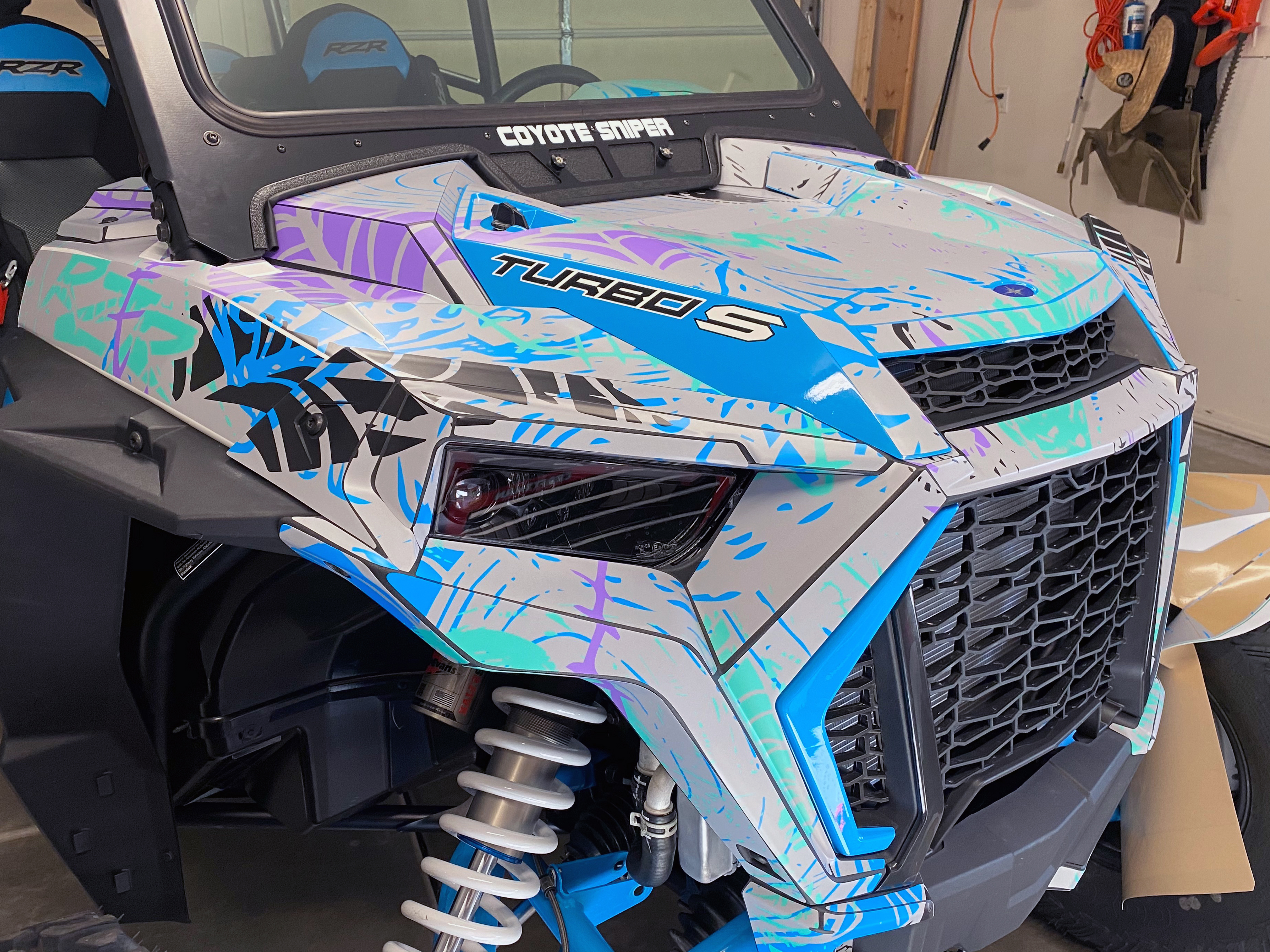 A Polaris RZR XP 4 Door 2018+ side-by-side with a gray, blue, and purple sketch grunge Braap Attack custom vinyl wrap.
