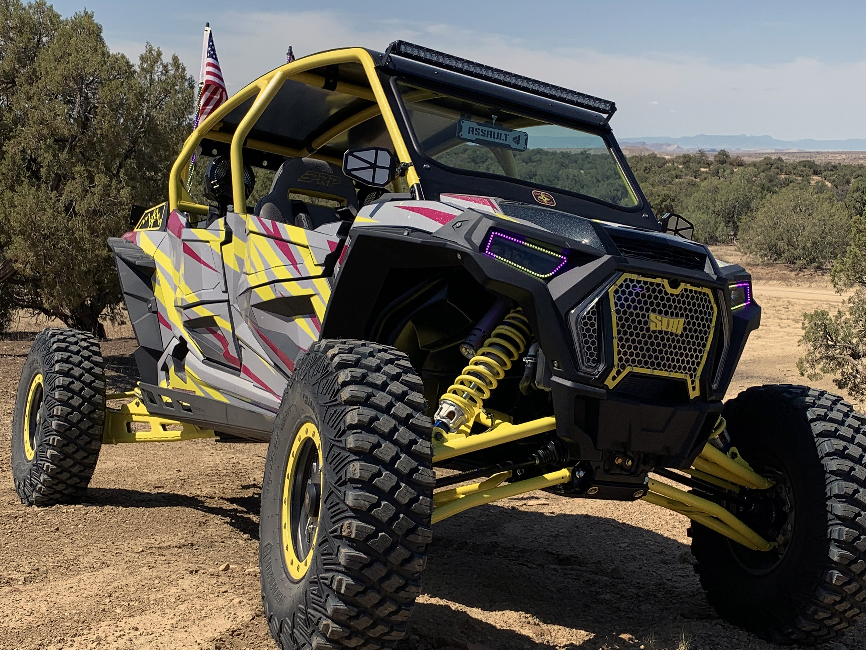 A Polaris RZR XP 4 Door 2018+ side-by-side with a gray, lime squeeze, and burgundy stripes Evolution custom vinyl wrap.