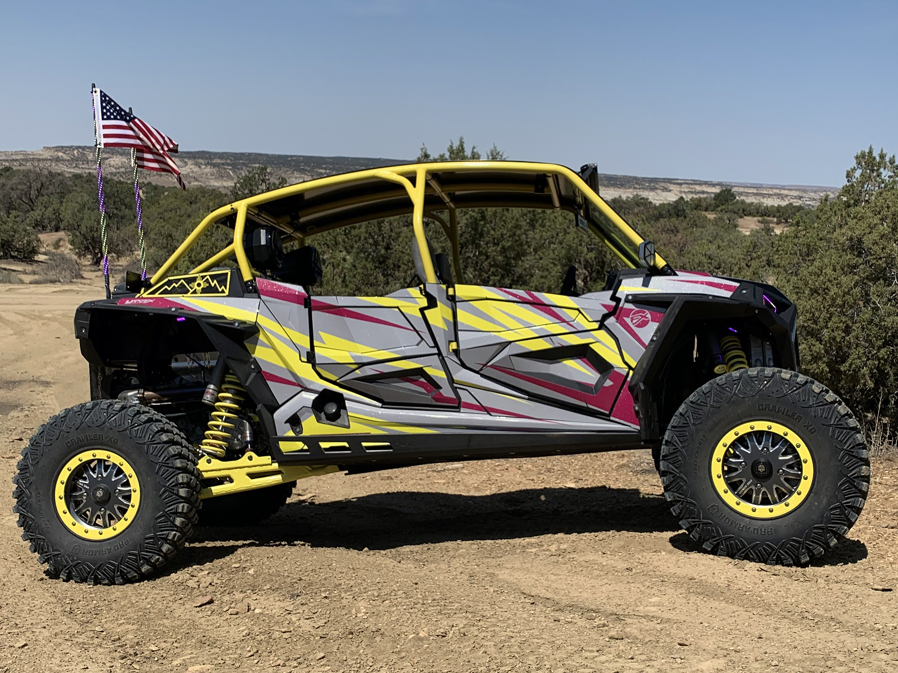 A Polaris RZR XP 4 Door 2018+ side-by-side with a gray, lime squeeze, and burgundy stripes Evolution custom vinyl wrap.