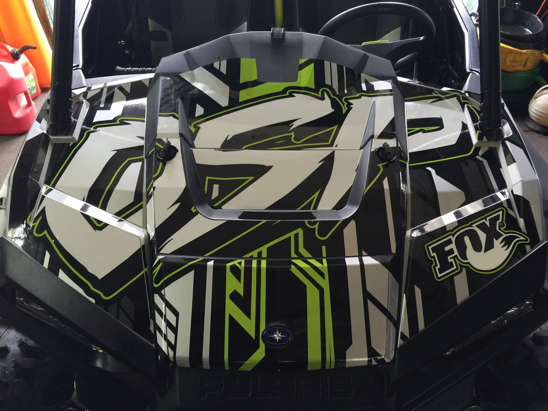 A Polaris RZR XP 2 Door side-by-side with a lime squeeze, gray, and black stripes Evasion custom vinyl wrap.