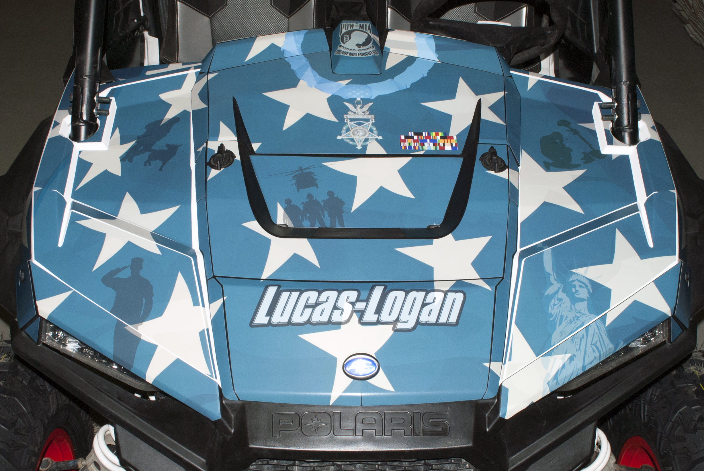 A Polaris RZR XP 4 Door side-by-side with a red, white, and blue American Fallen Heroes custom vinyl wrap.