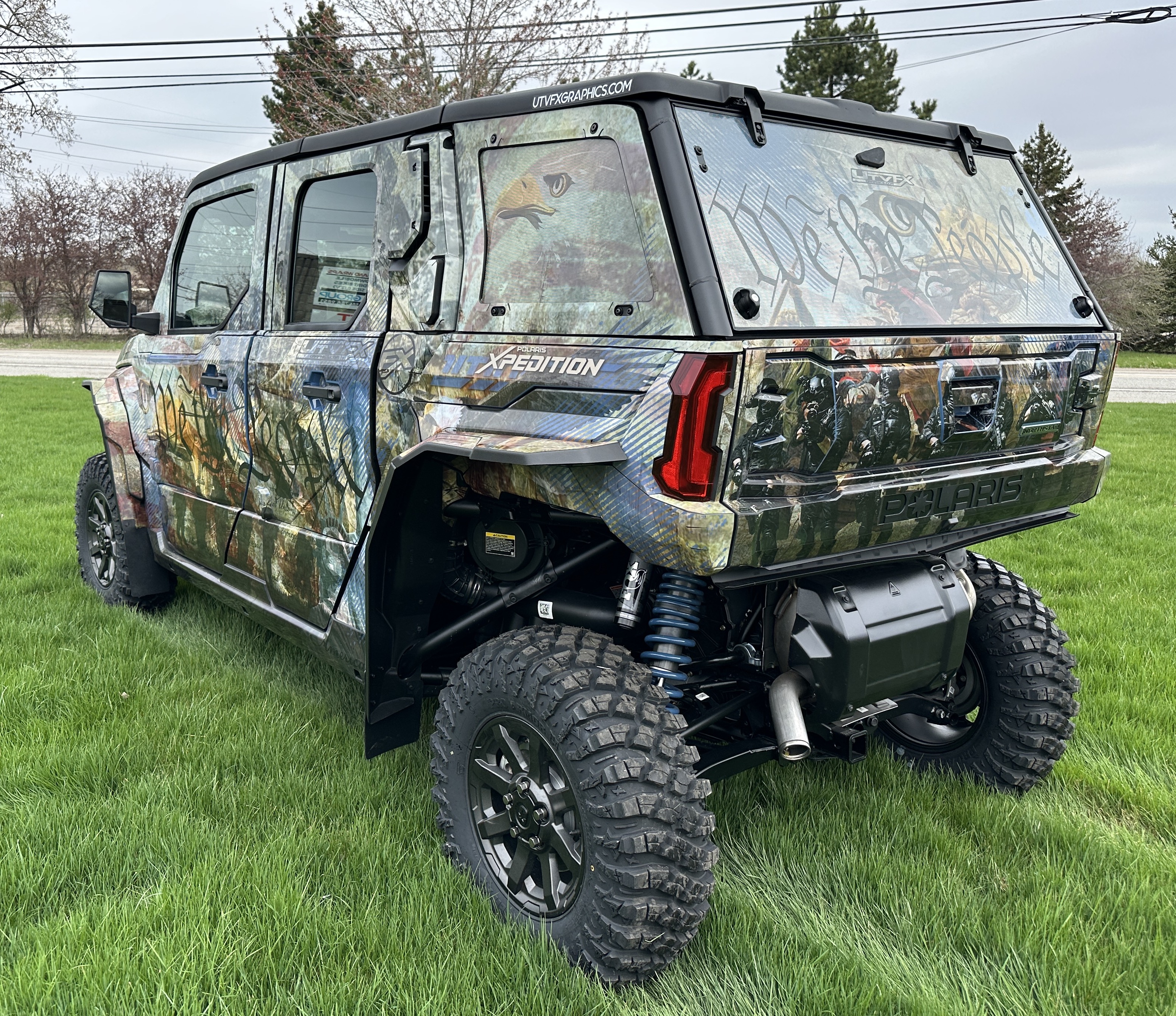 A Polaris Xpedition 4 door side-by-side with a We the People custom vinyl wrap.