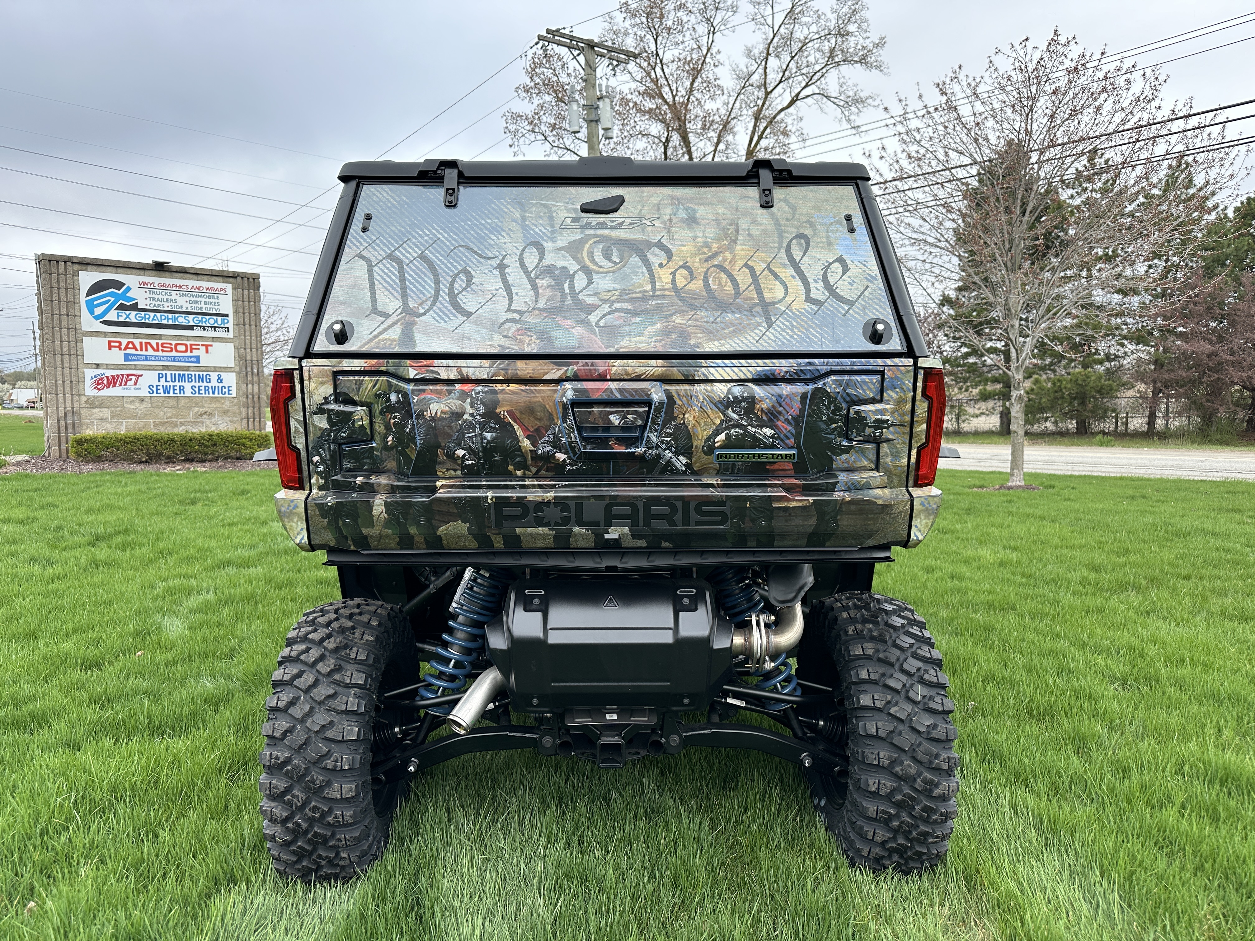 A Polaris Xpedition 4 door side-by-side with a We the People custom vinyl wrap.