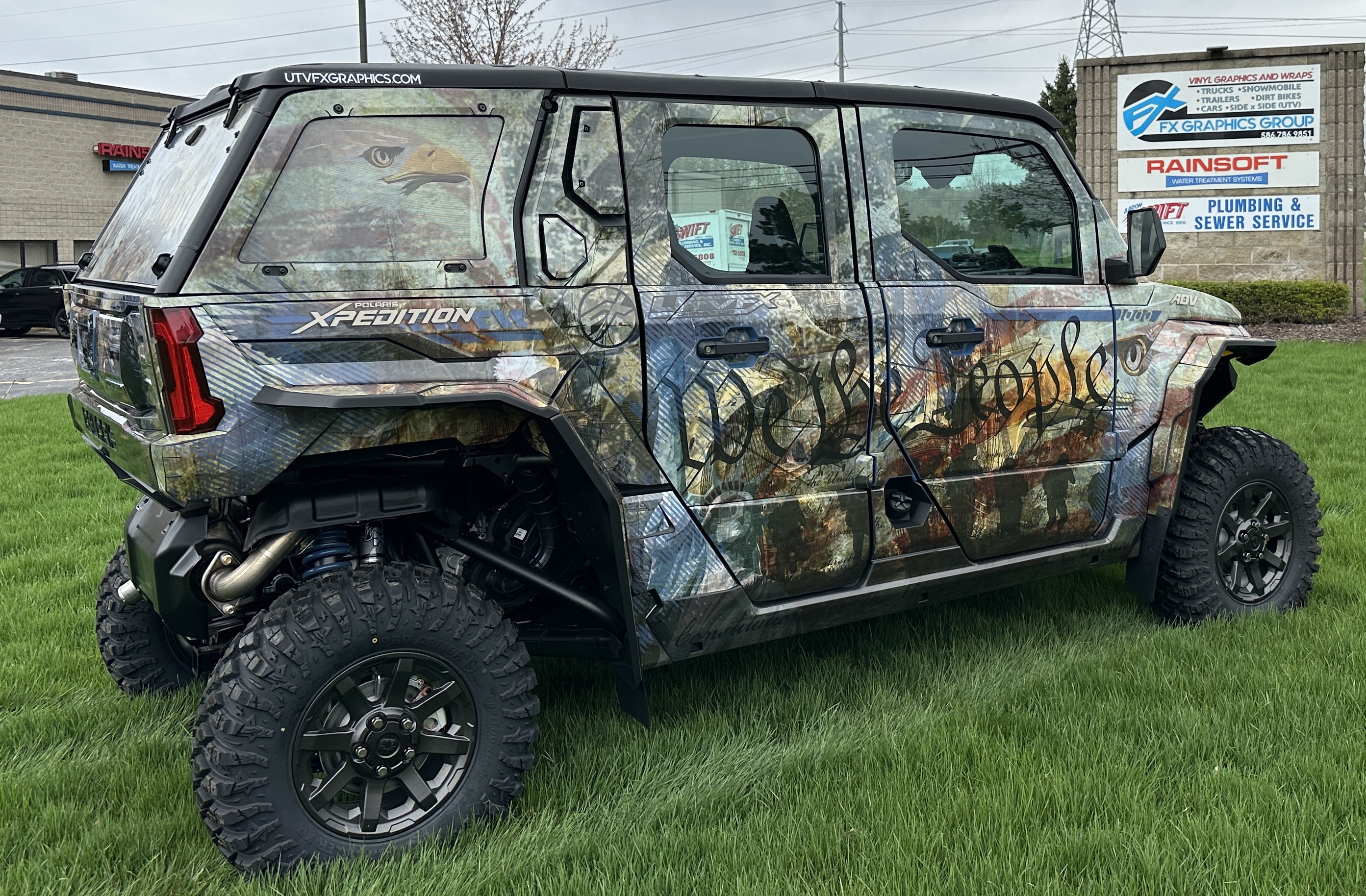 A Polaris Xpedition 4 door side-by-side with a We the People custom vinyl wrap.