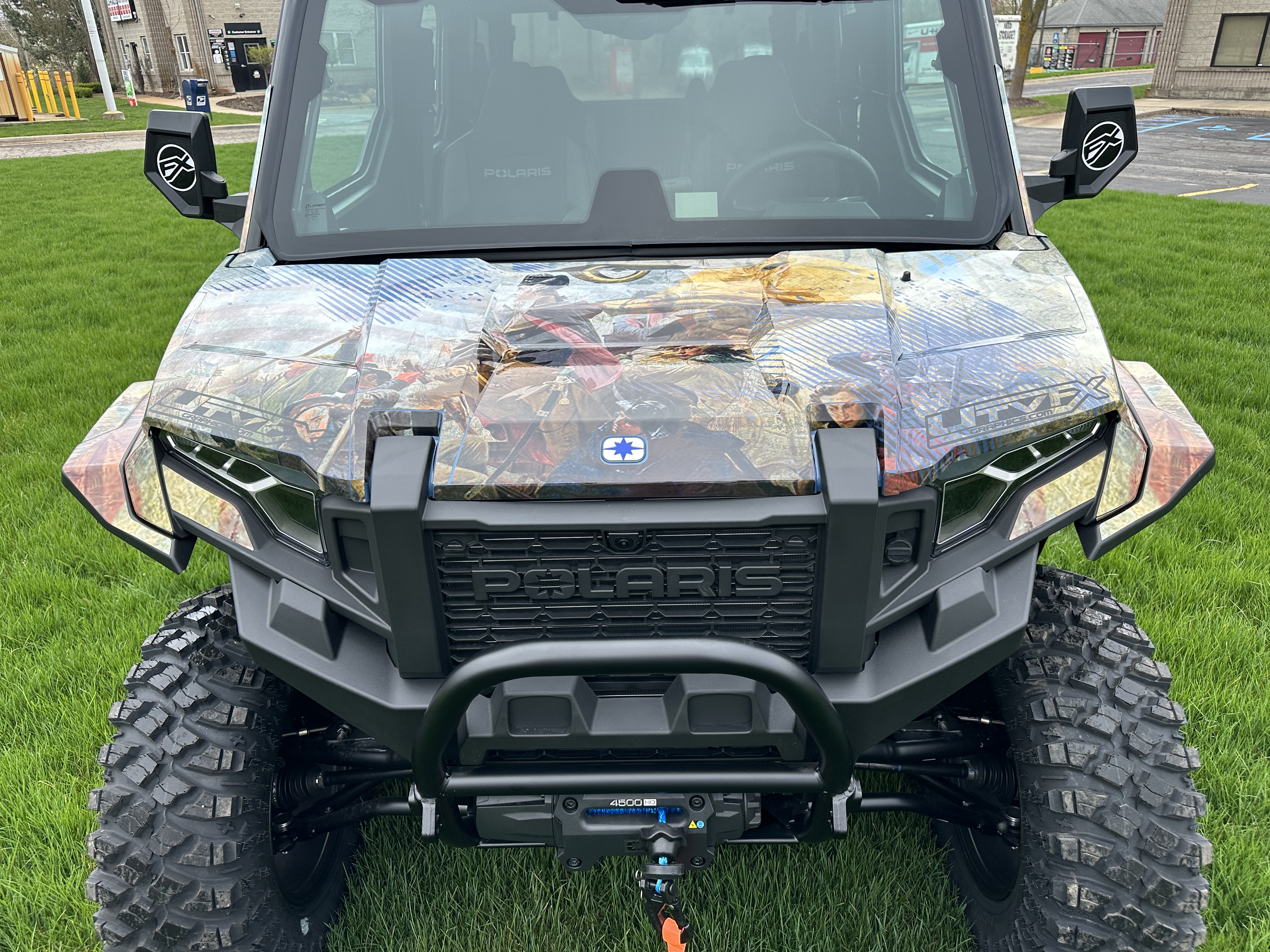 A Polaris Xpedition 4 door side-by-side with a We the People custom vinyl wrap.