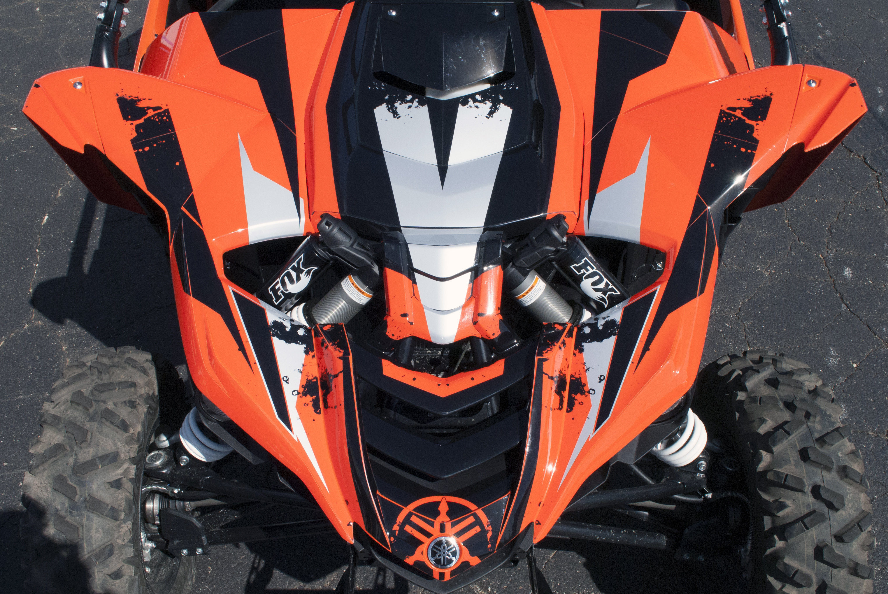 A Yamaha YXZ1000R side-by-side with a orange, black, and gray grunge stripe Race custom vinyl wrap.