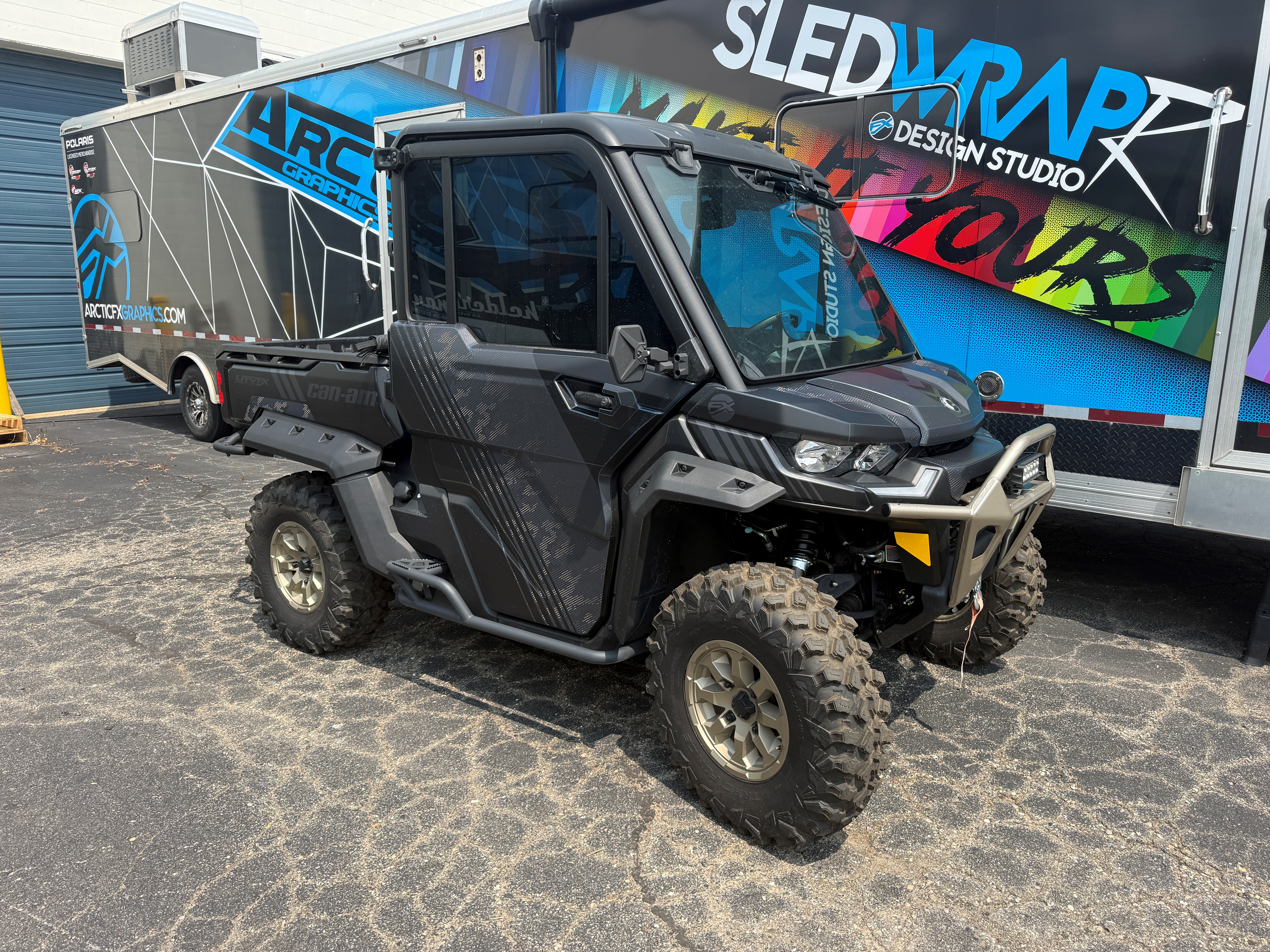 A CanAm Defender with a black, navy blue, and beige Armada custom vinyl wrap with matte laminate