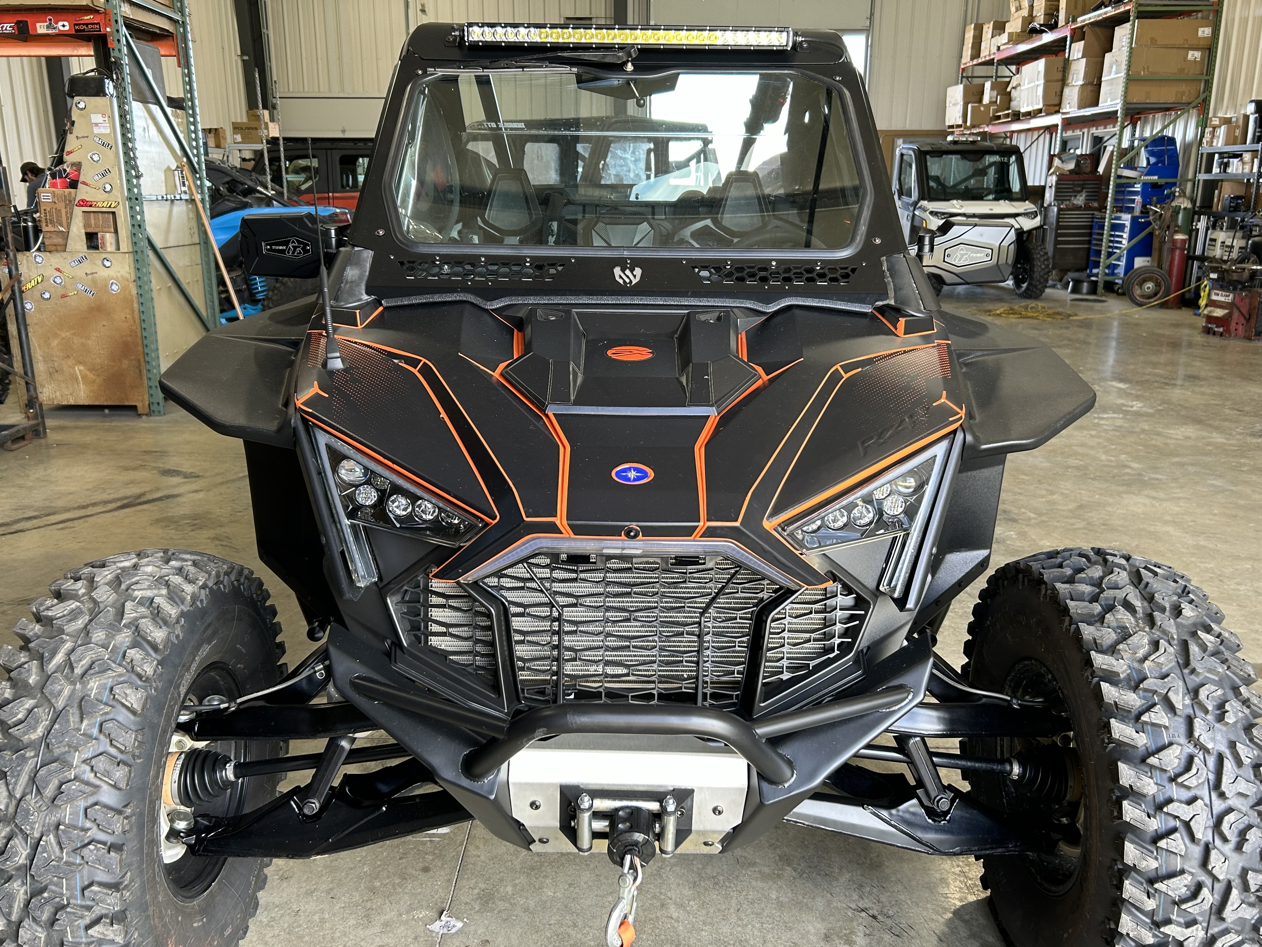 A Polaris RZR PRO XP 2 Door side-by-side with a black and axys burst Armada custom vinyl wrap with matte laminate.