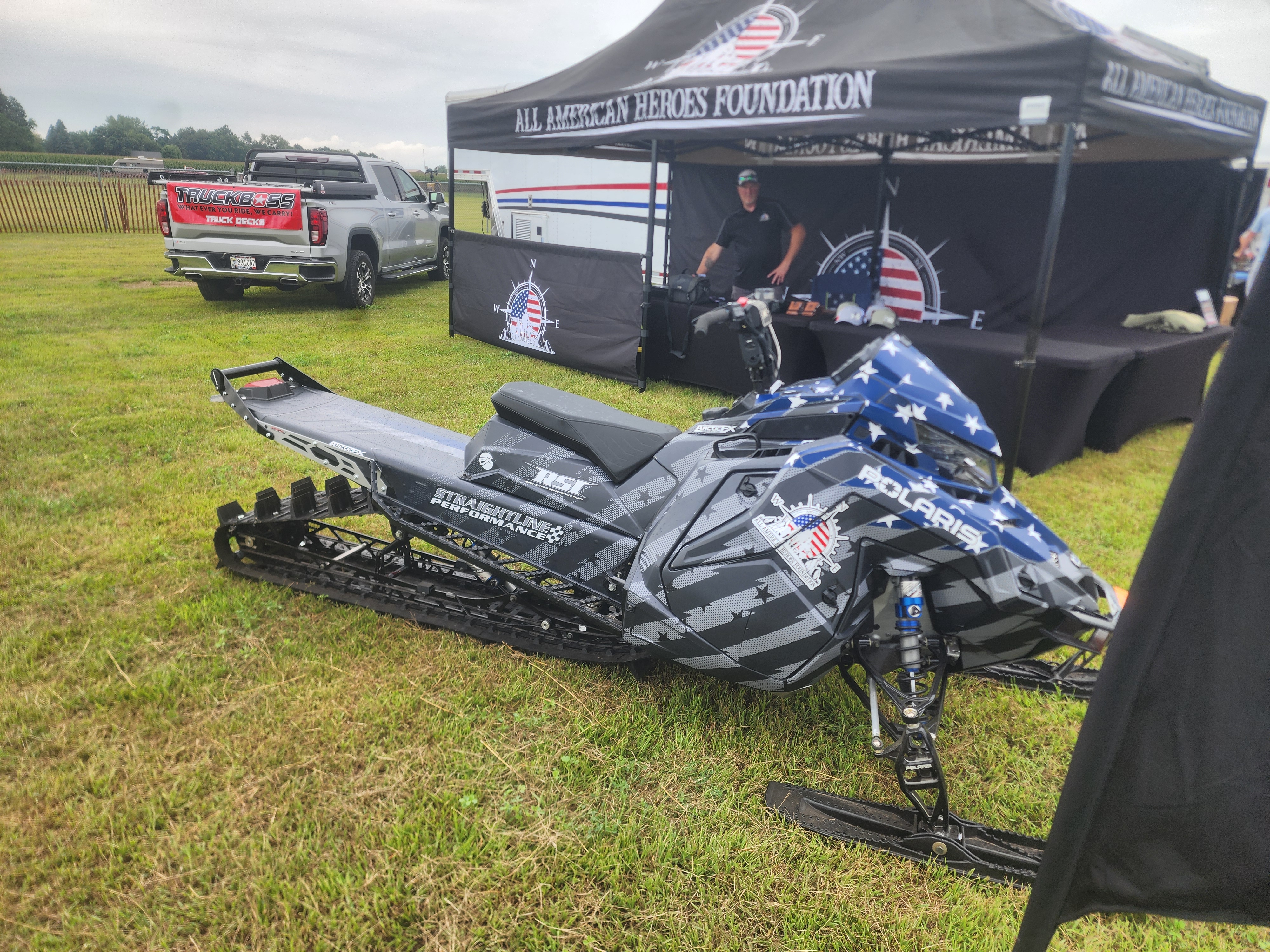 A Polaris Matryx Mountain snowmobile with a white, gunmetal gray, charcoal gray, black, and navy blue Electro custom vinyl wrap with matte laminate.